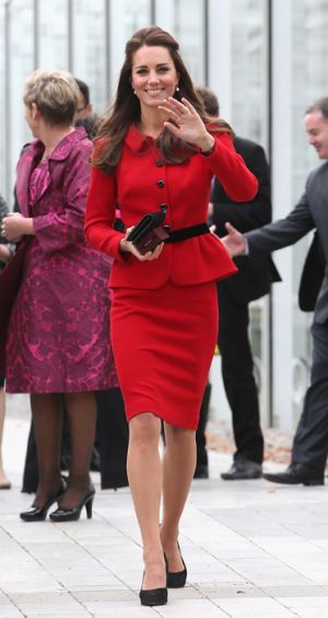 Kate in Christchurch -  KM in a red Luisa Spagnoli suit cinched in at the waist by a black belt.jpg